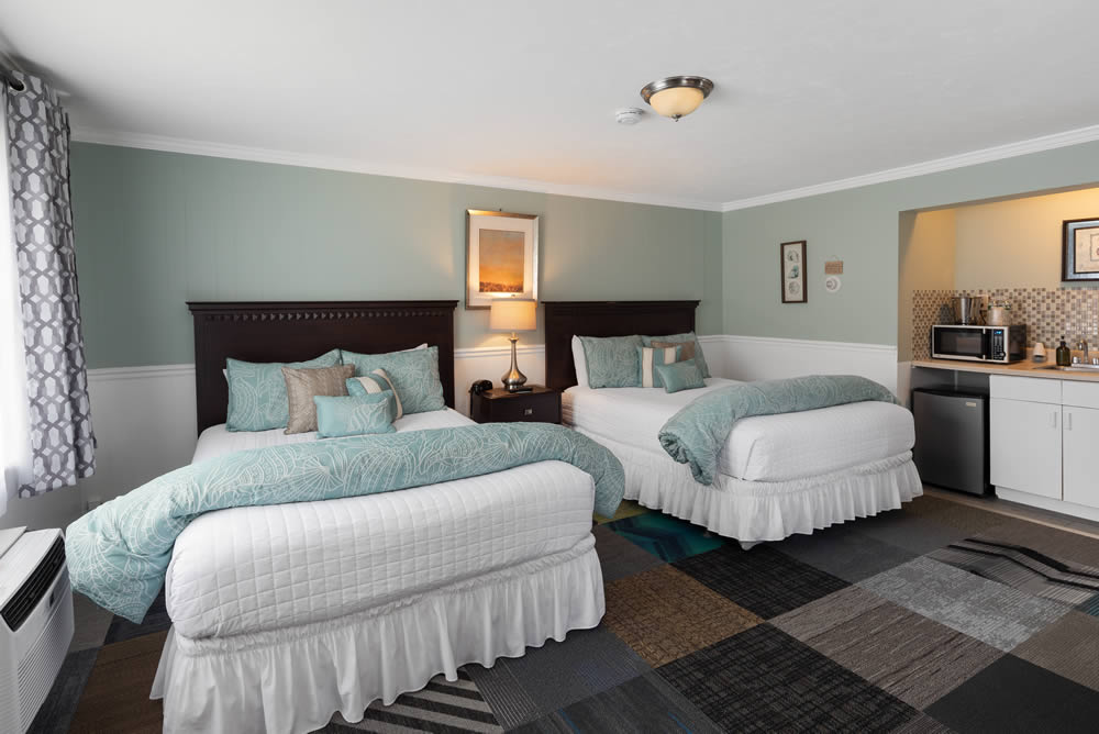 hotel room with two beds and kitchenette